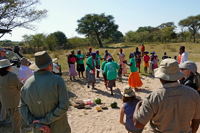 Villagers in Nkoba, Zimbabwe dance and give offerings of food to donors who helped fund a community well