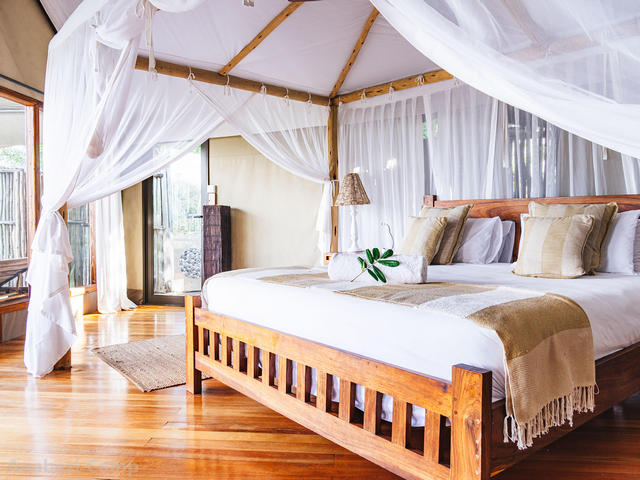 Bed with canopy at Anabezi Camp, a luxury safari camp in the Lower Zambezi of Zambia