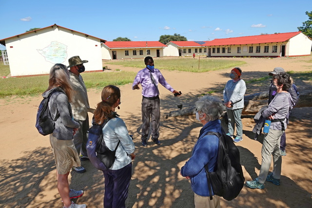The headmaster of Ngamo School giving a small group of safari guests a tour of the school