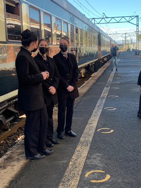 staff stand outside rovos rail train