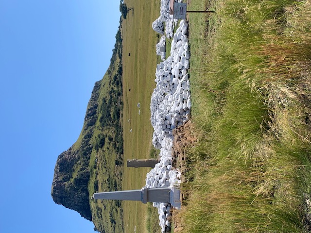 battle monument with a rocky hill behind it