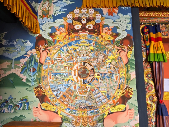 Close-up painting of the Wheel of Life, showing intricate depictions of the entire cycle of life.