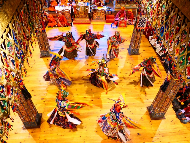 Monks inside a Monastery practicing a masked dance at Punakha Dzong in Bhutan